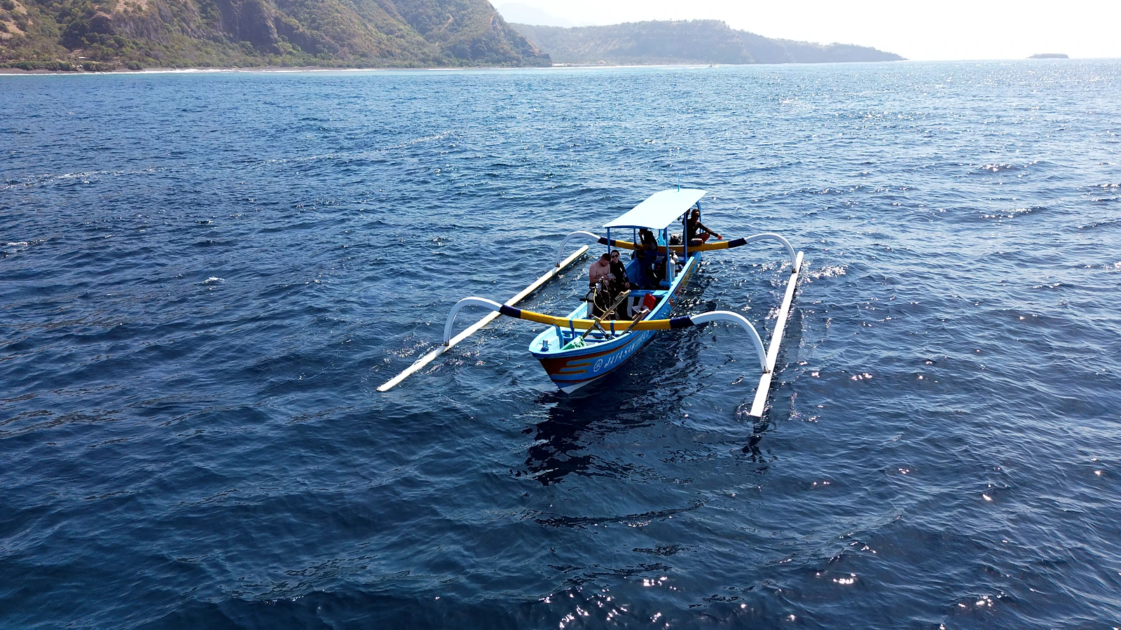 Traditional dive boat off Bali’s coast travelling towards another diving region
